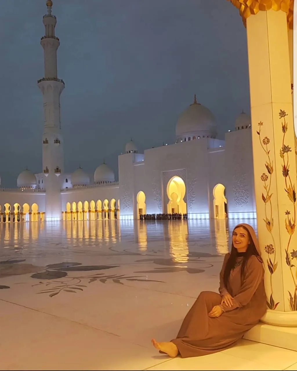 Person sitting inside Sheikh Zayed Grand Mosque in Abu Dhabi