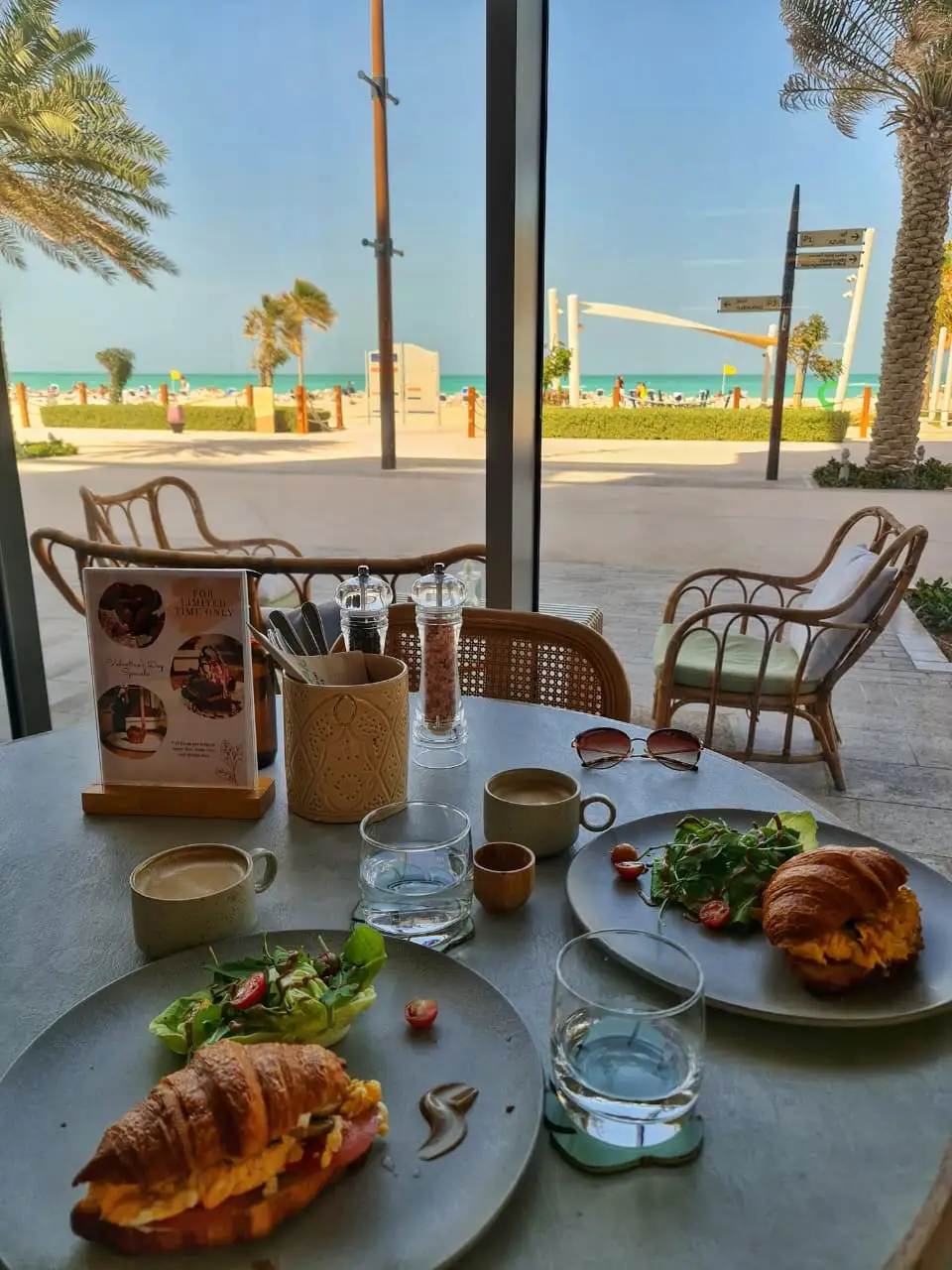 Restaurant table with croissants and sea view