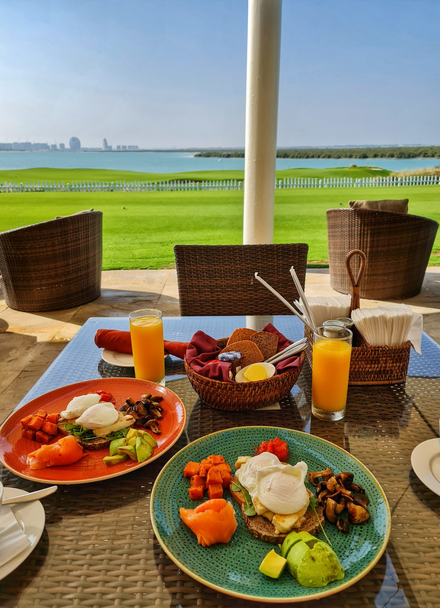 Breakfast with a view of the golf course and ocean scenery at a coastal resort.