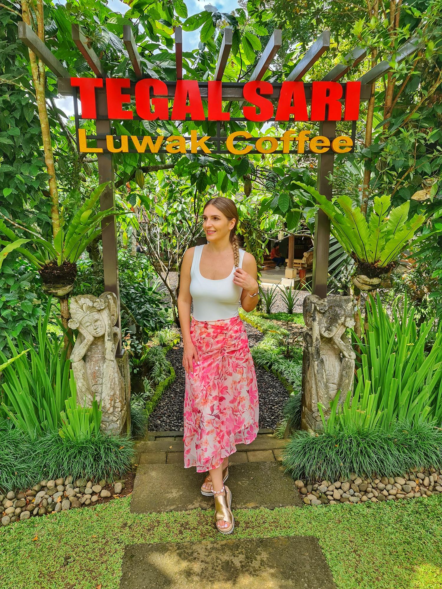 Female traveler exploring a coffee plantation in Ubud, Bali, surrounded by lush tropical greenery and traditional coffee plants.