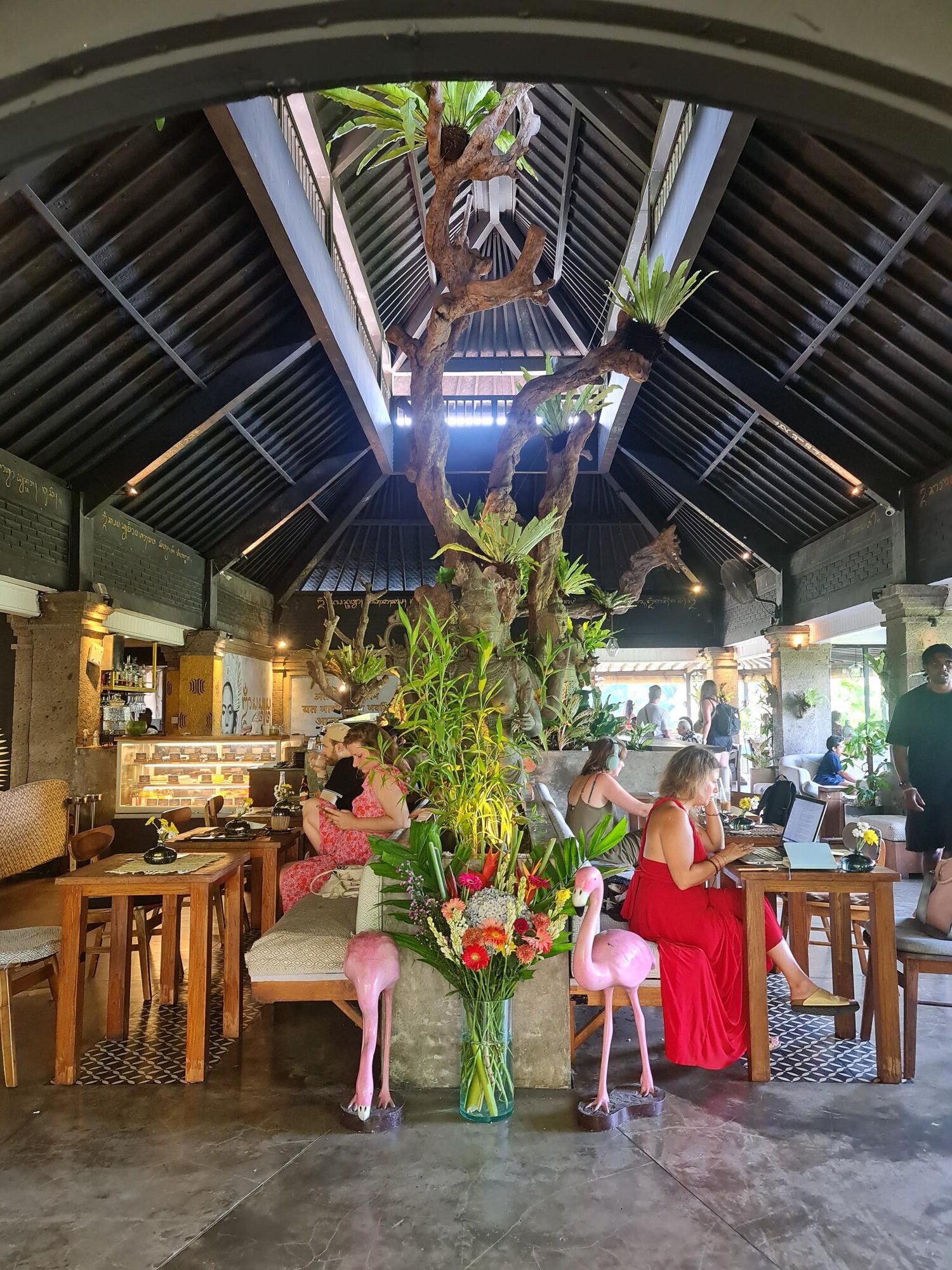 Boho-style interior of Zest Ubud surrounded by lush greenery