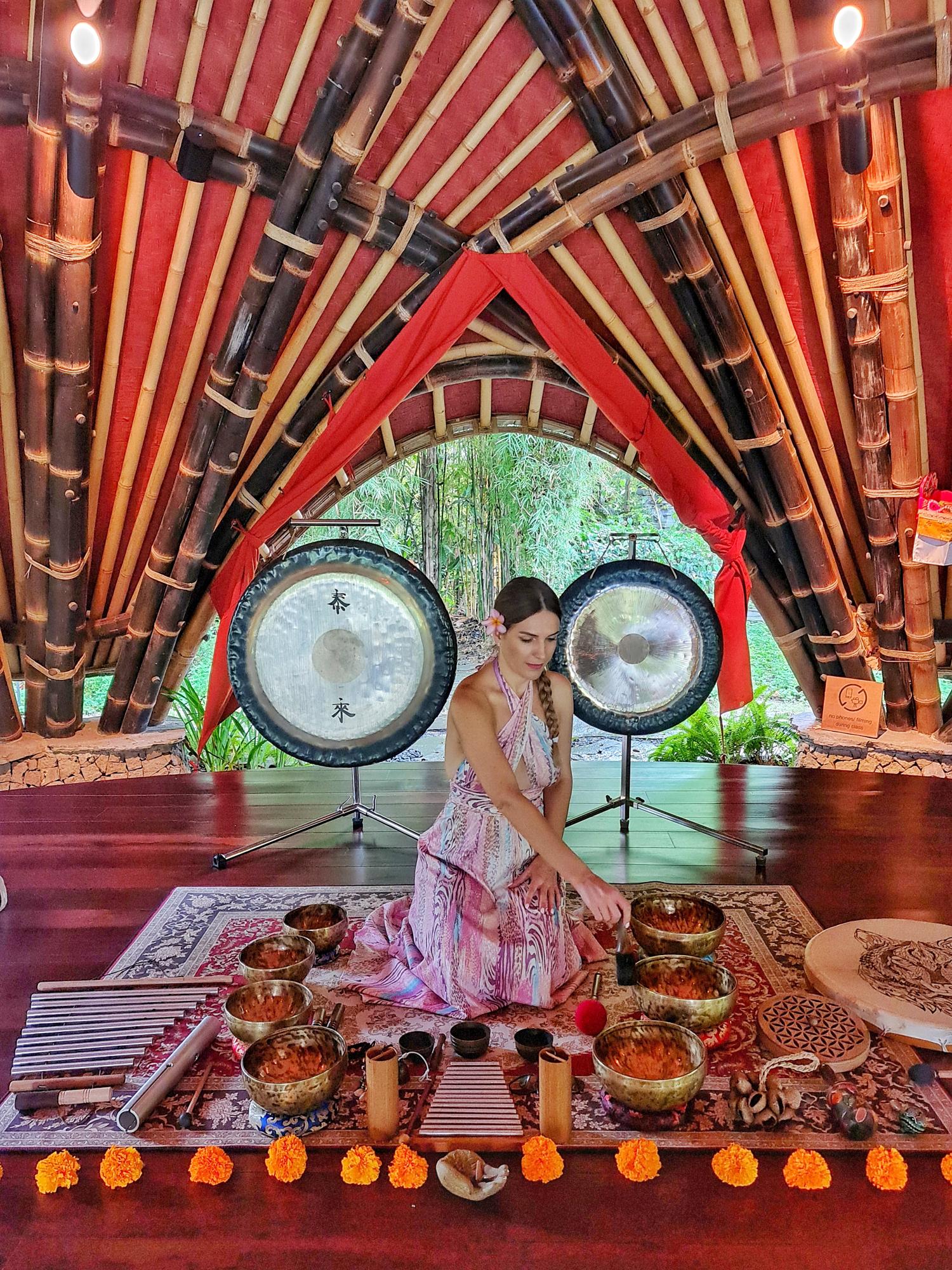Person performing sound healing at Alchemy Yoga Center in Ubud.