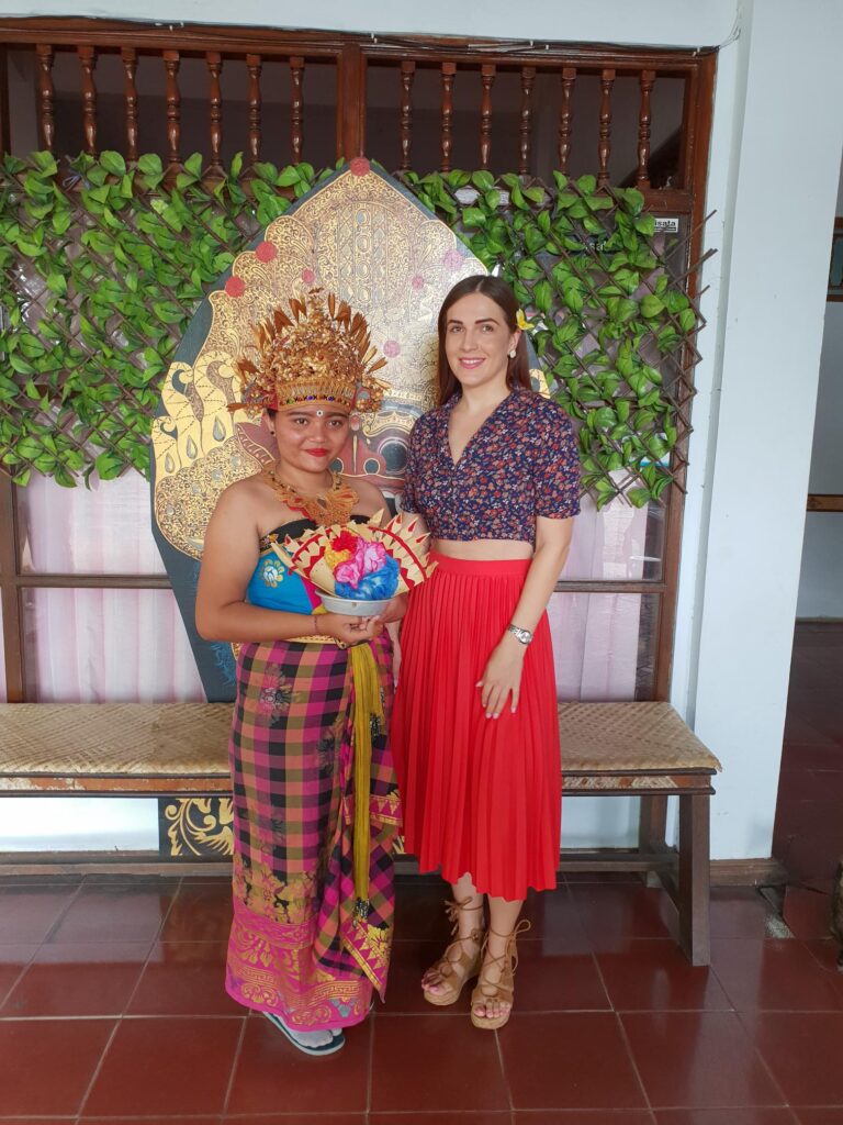 Traveler standing with a woman dressed in traditional attire