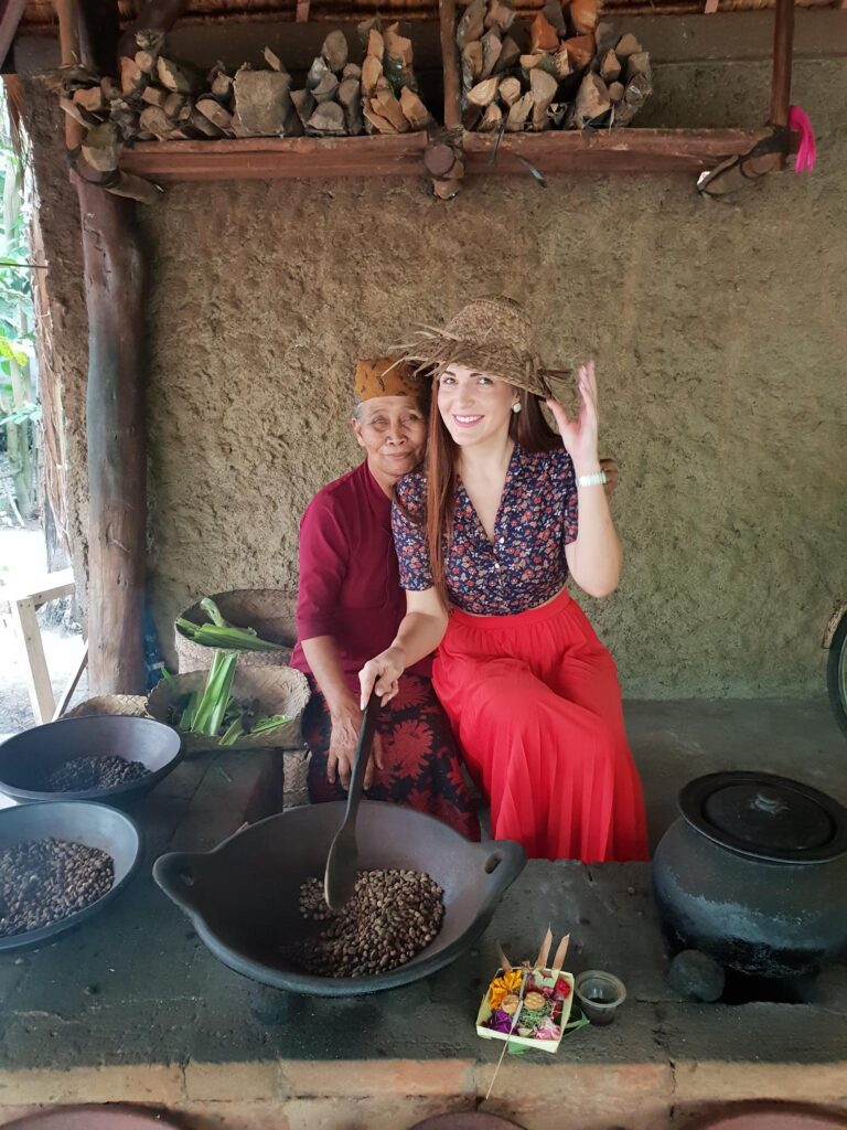 Traveler and an elderly woman preparing Luwak coffee beans at a plantation