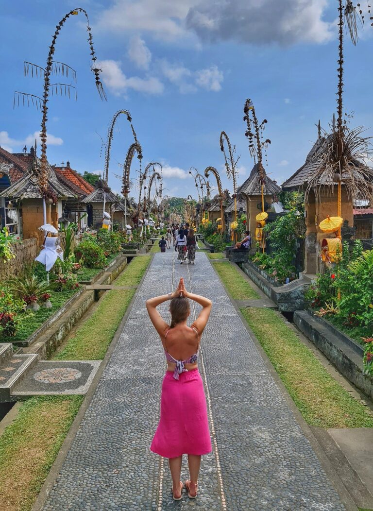 Quiet stone street with traditional houses and a traveler walking