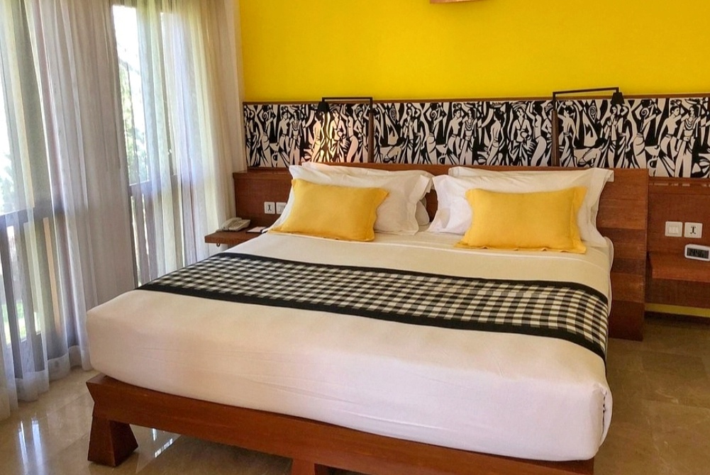 Luxury pool in Bali surrounded by lush tropical greenery and palm trees