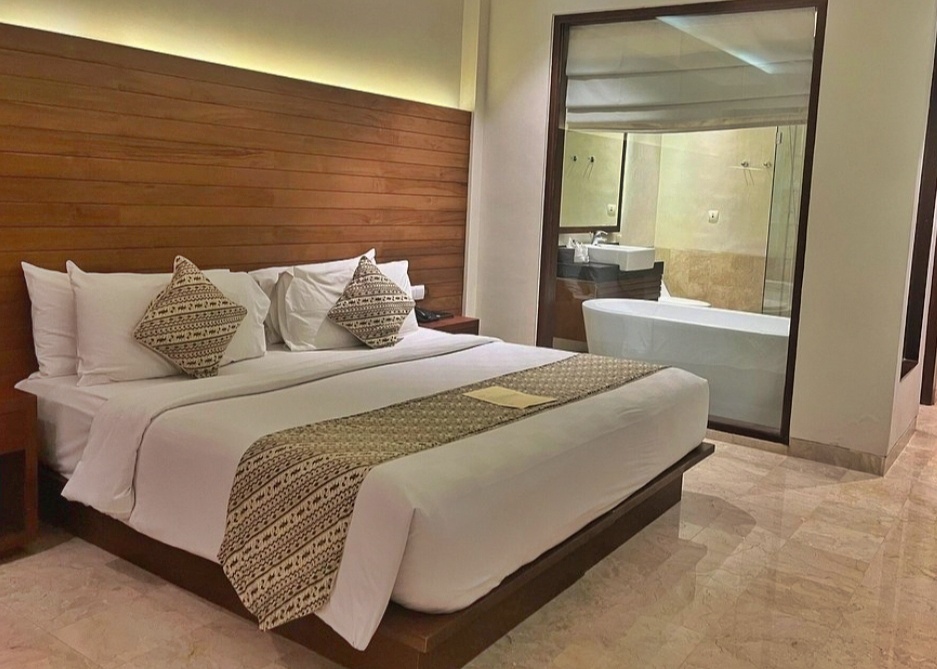 Hotel room in Bali with glass bathroom doors and a visible bathtub