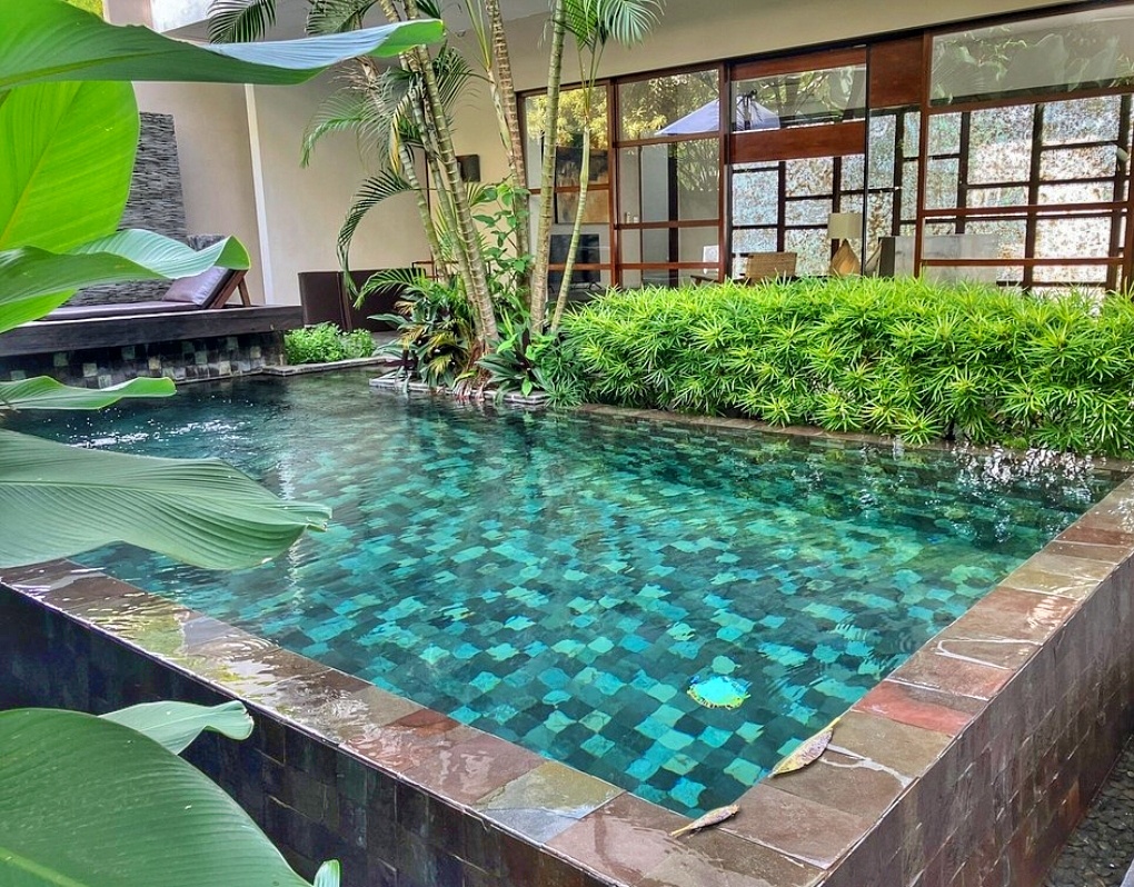 Cozy wooden hotel room in Bali with a mosquito net over the bed