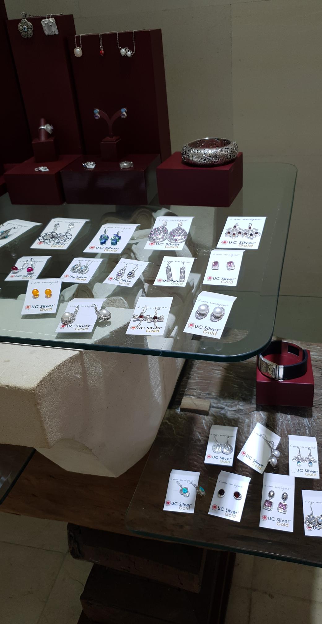 Display of silver earrings at a market booth