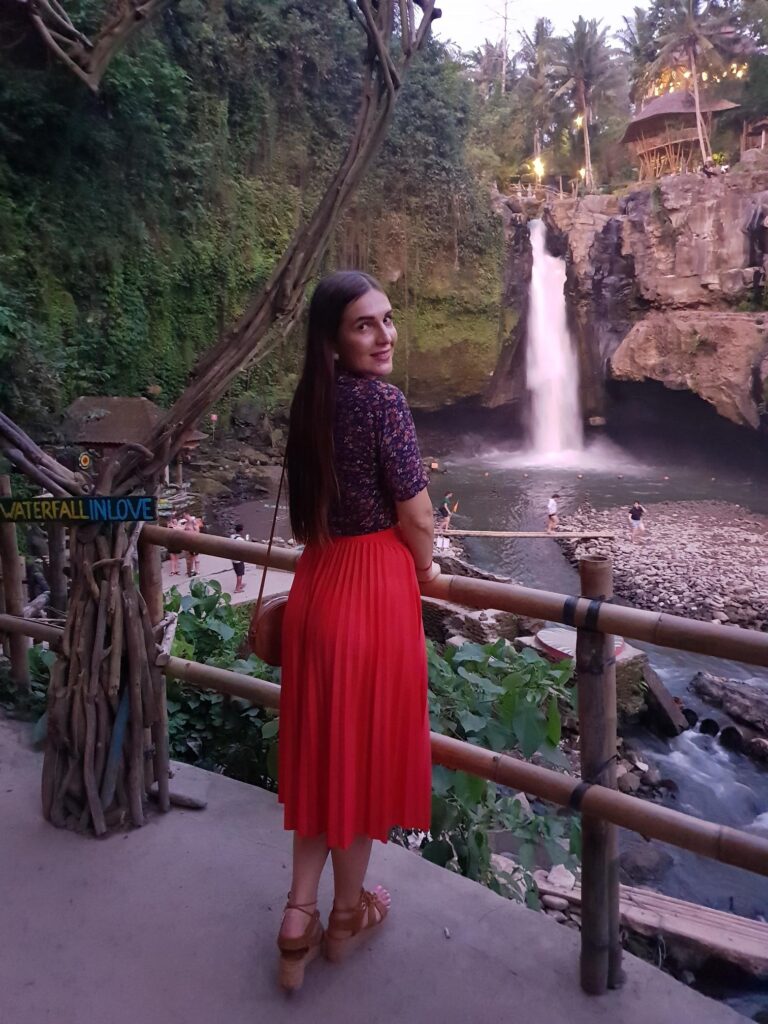 Lush jungle waterfall cascading over rocks surrounded by dense tropical greenery