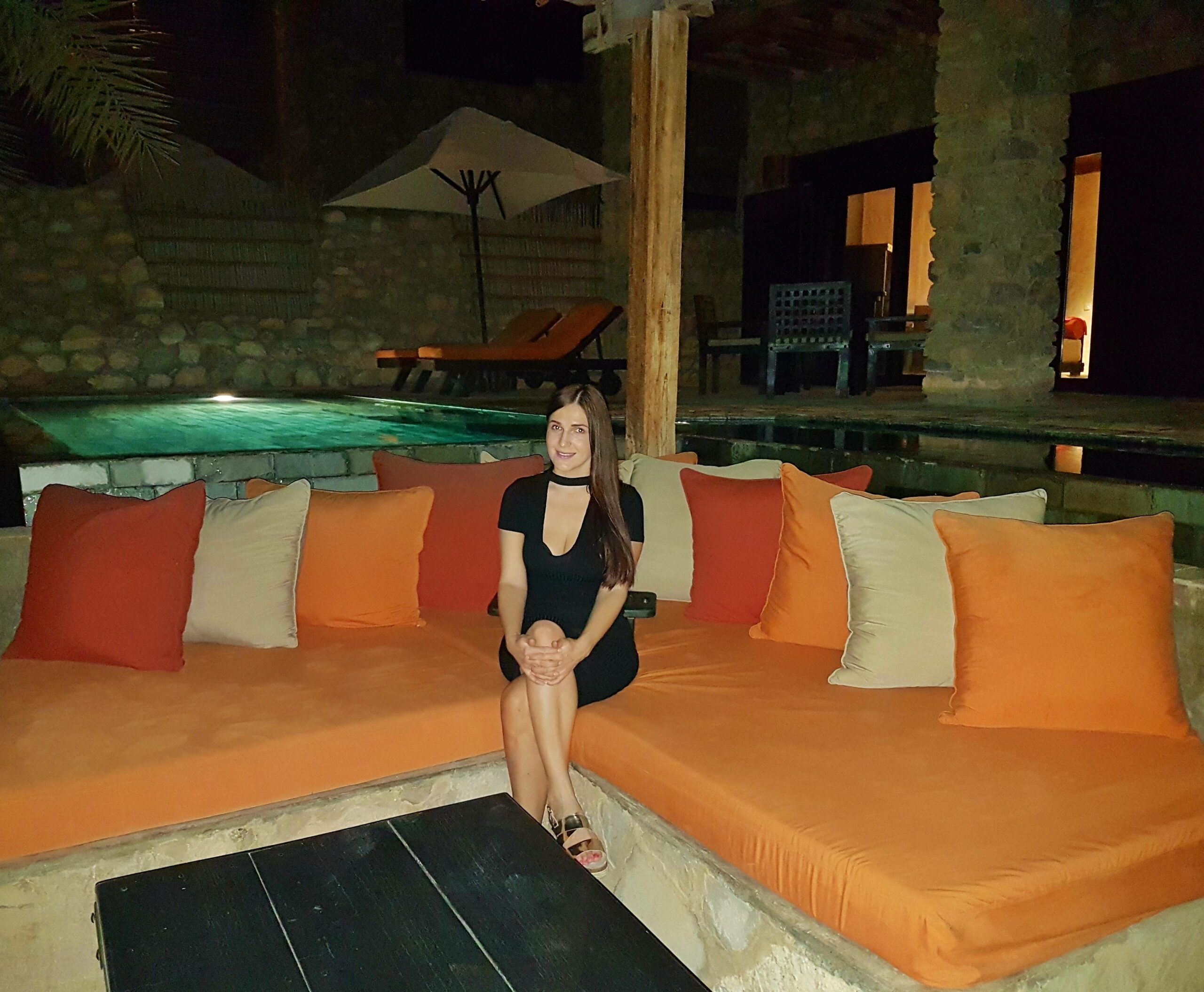 Private pool villa at Six Senses Zighy Bay at night with pool, lounge area, and cozy seating