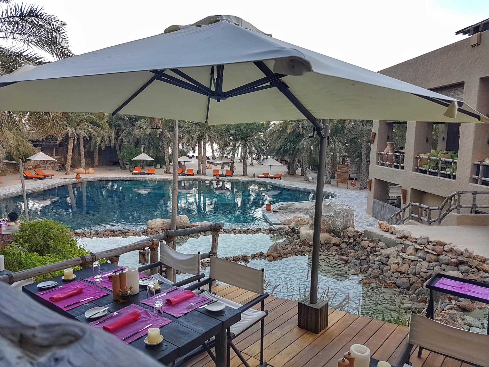 Beautiful pools and outdoor dining area at Six Senses Zighy Bay surrounded by mountains