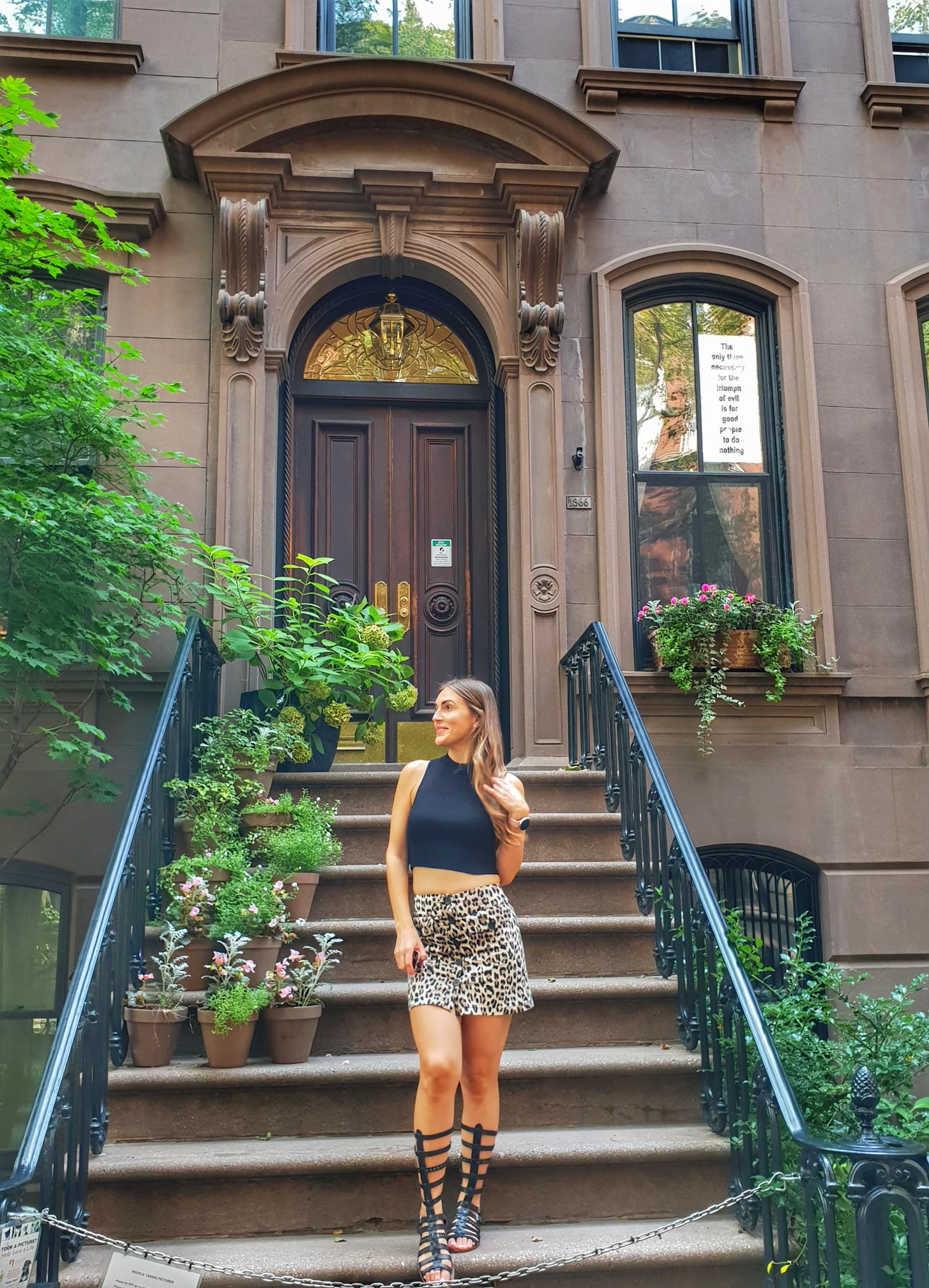 Woman in front of Carrie Bradshaw apartment West Village NYC