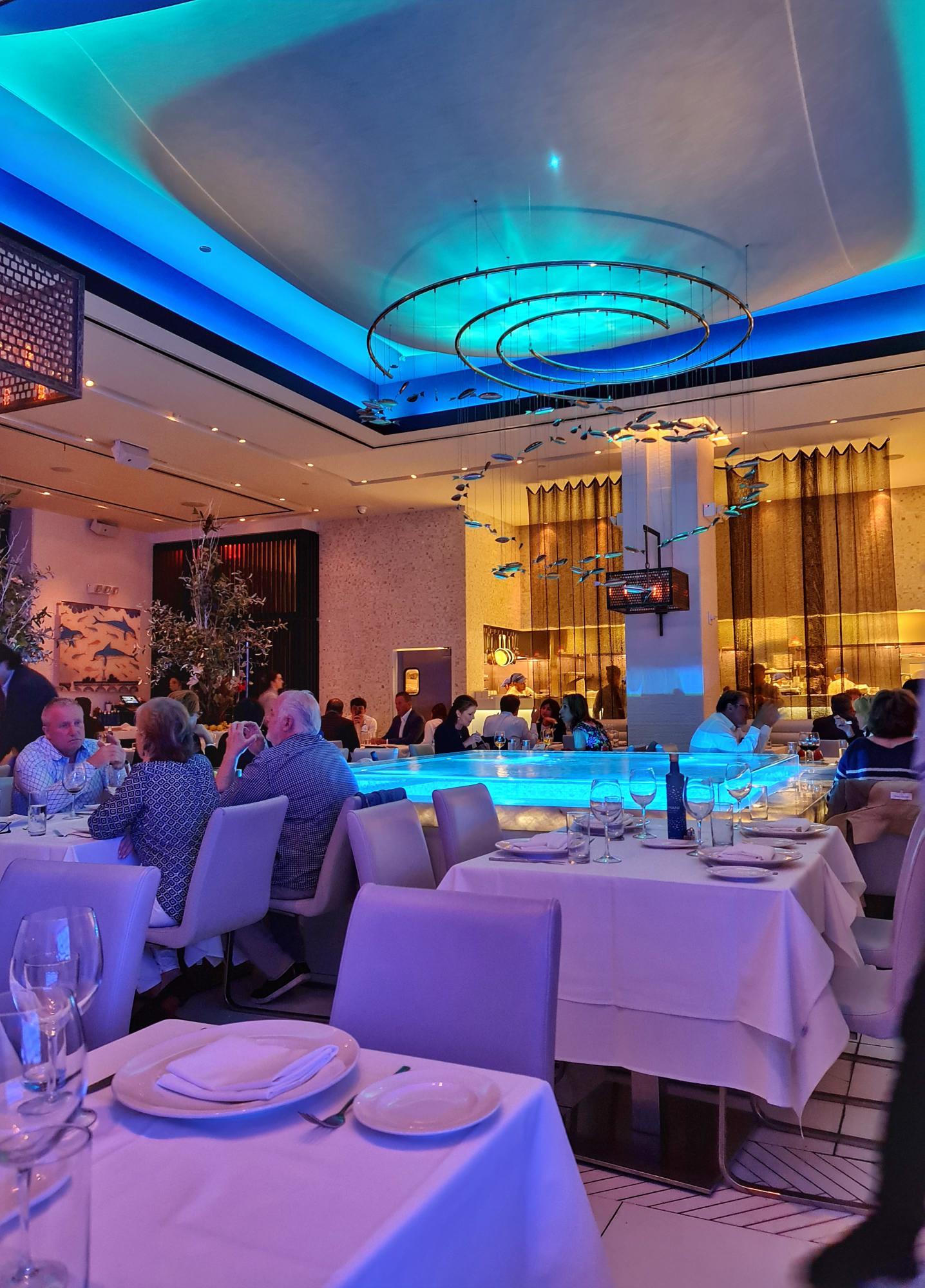Luxurious interior with a pool and fine-dinning setting in Limani restaurant NYC