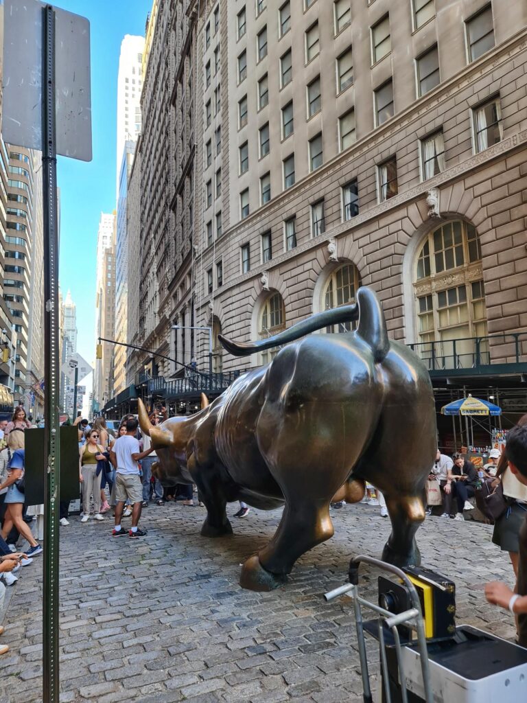 Charging Bull statue on Wall Street in New York City symbolizing financial strength and power