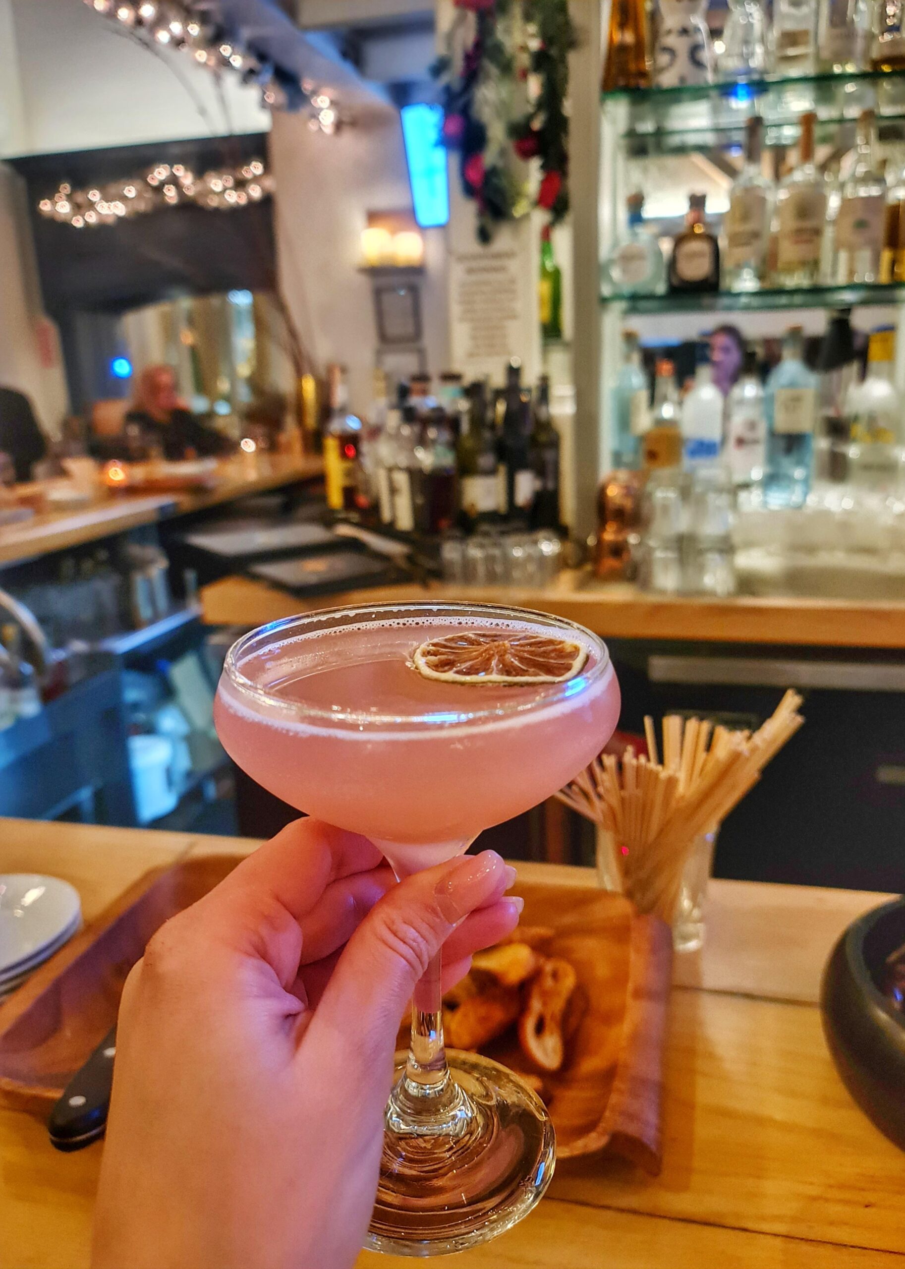 Holding a cocktail in a stylish bar