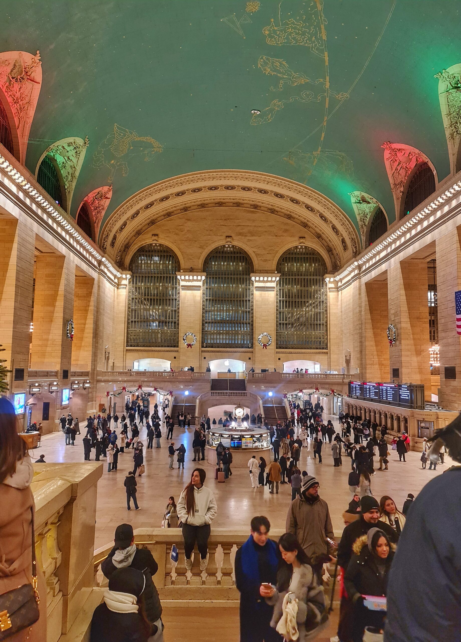 Taking a photo inside Grand Central Terminal in New York City, showcasing the historic interior architecture. 