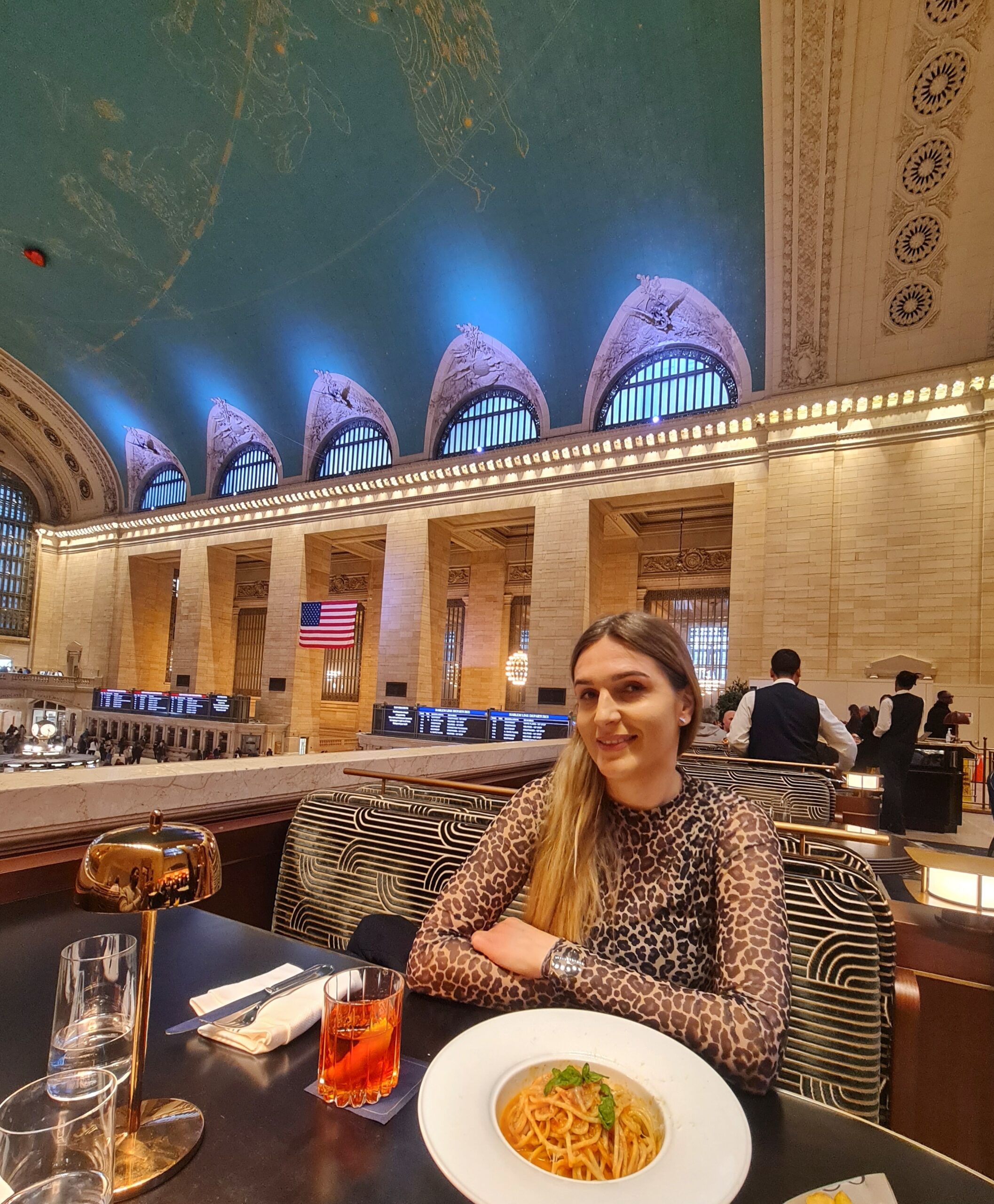 Dining inside Grand Central Terminal in New York City with food and views of the historic interior.