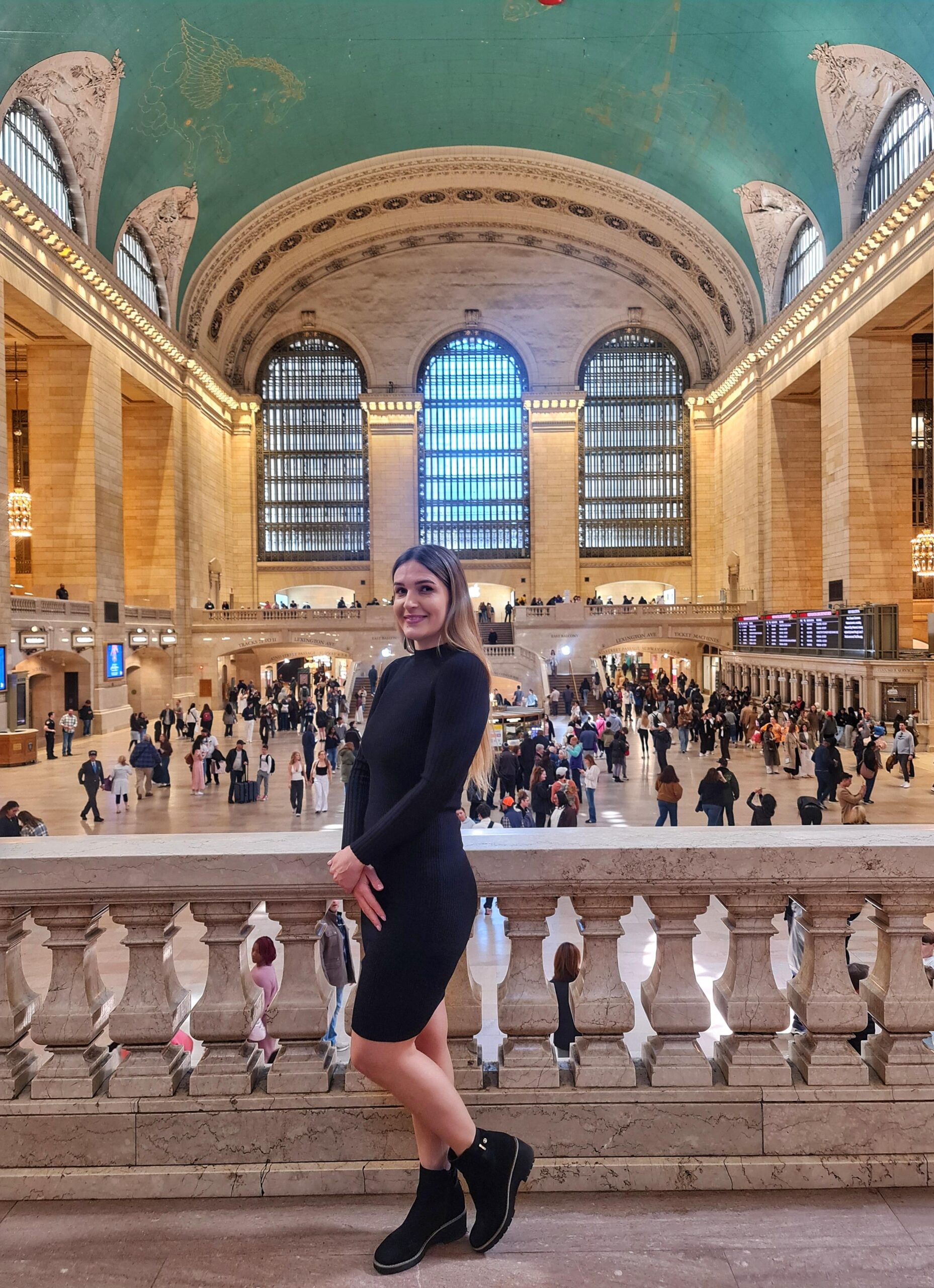 Woman standing inside Grand Central Terminal main hall in New York City