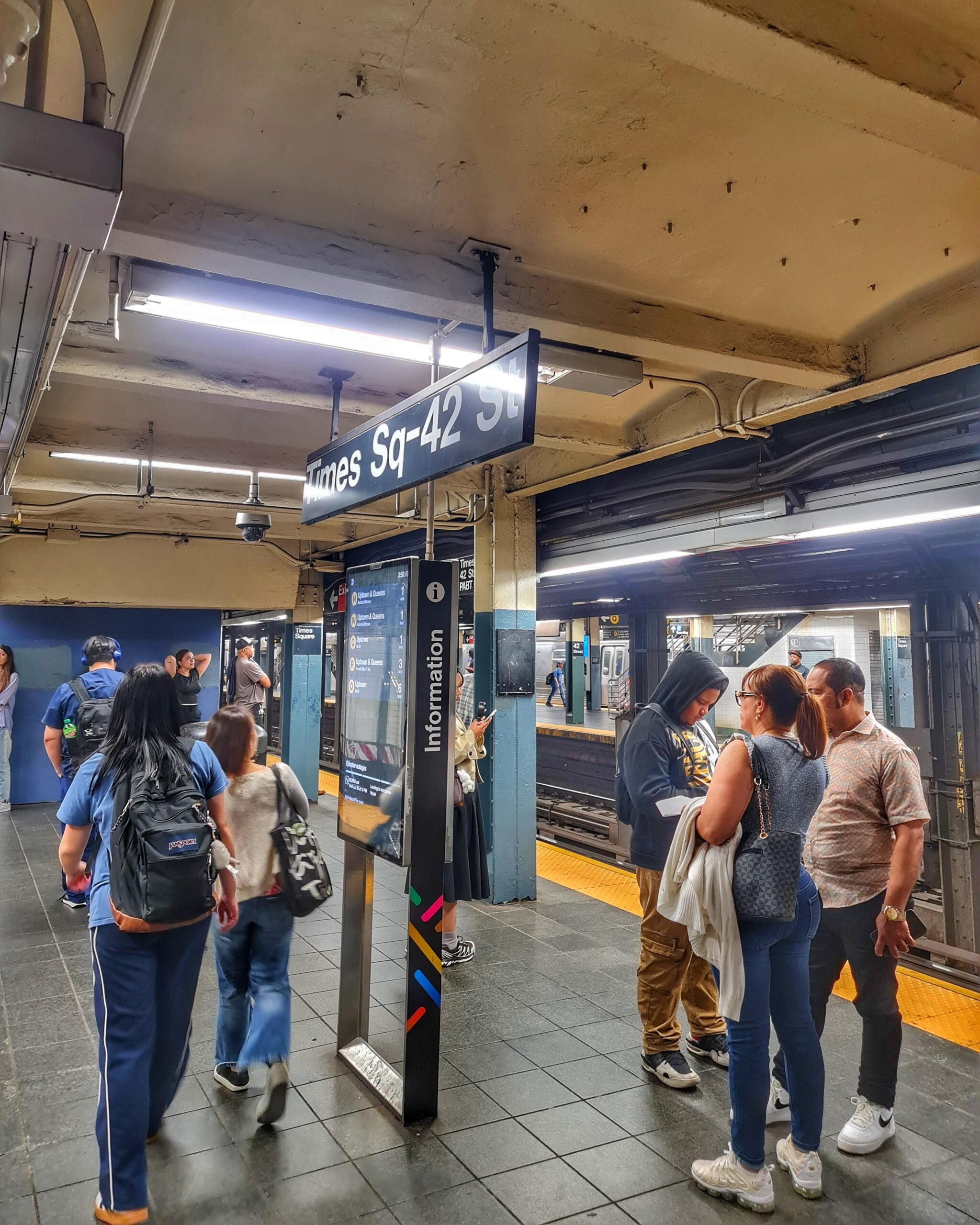Interior of NYC subway tunnel with train arriving at the station in Manhattan