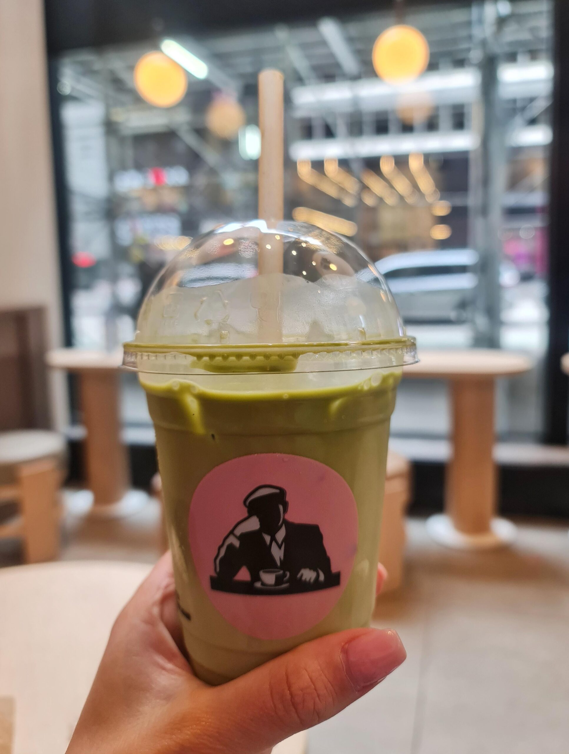Holding a matcha latte inside Joe & The Juice café in New York City.