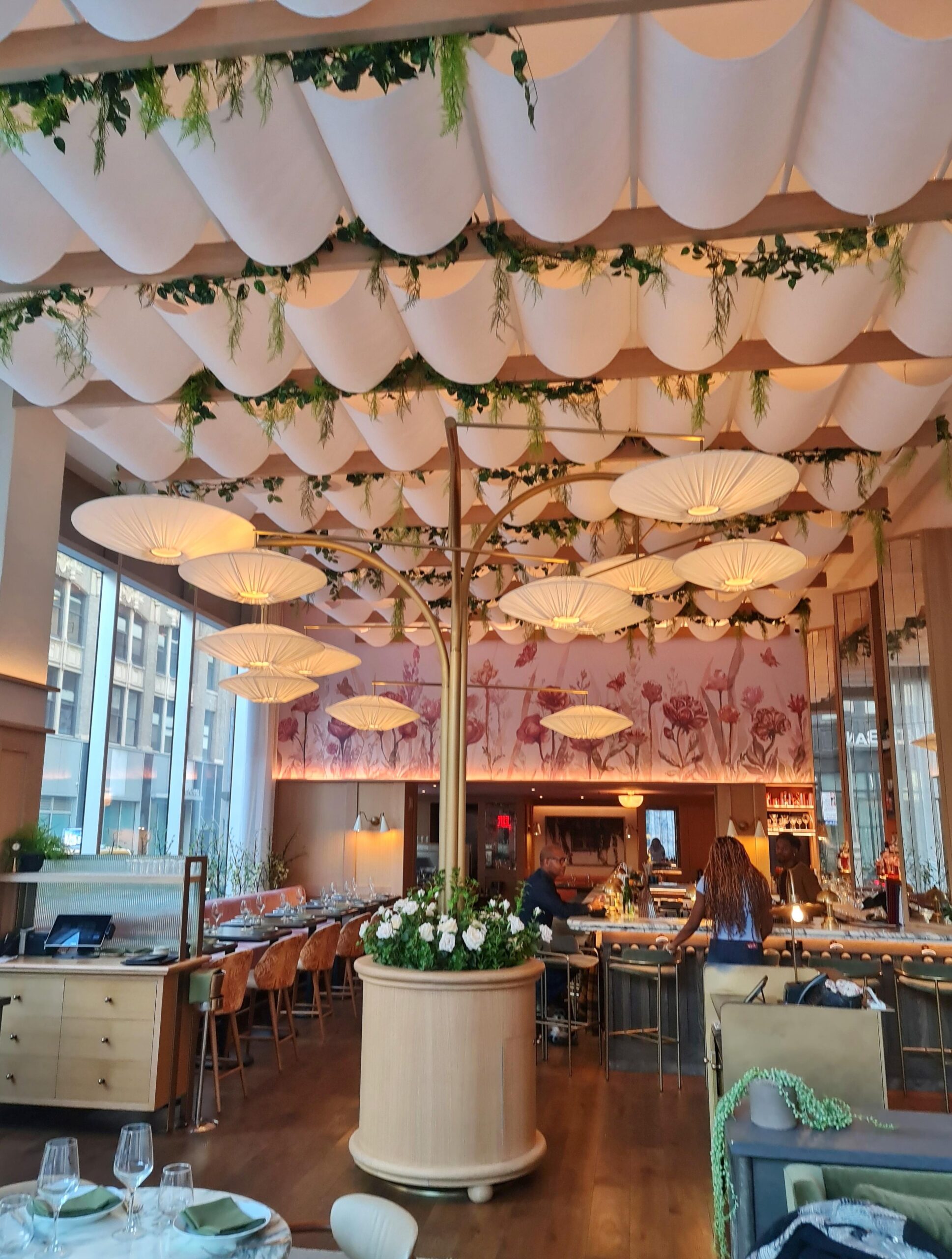 Elegant pink and floral interior design of Park Rose restaurant in New York City.