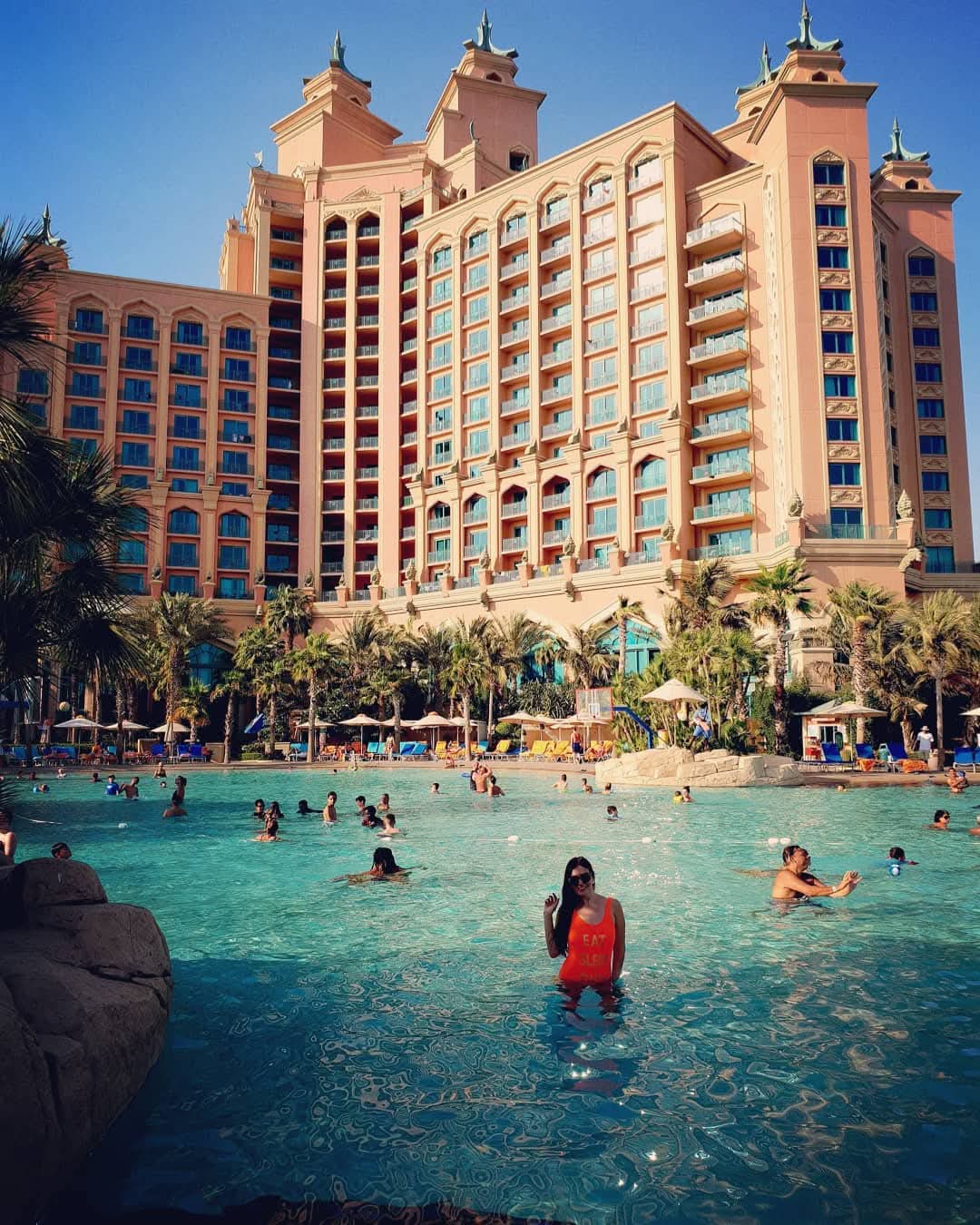 Woman in pool overlooking Atlantis The Palm on Palm Jumeirah in Dubai