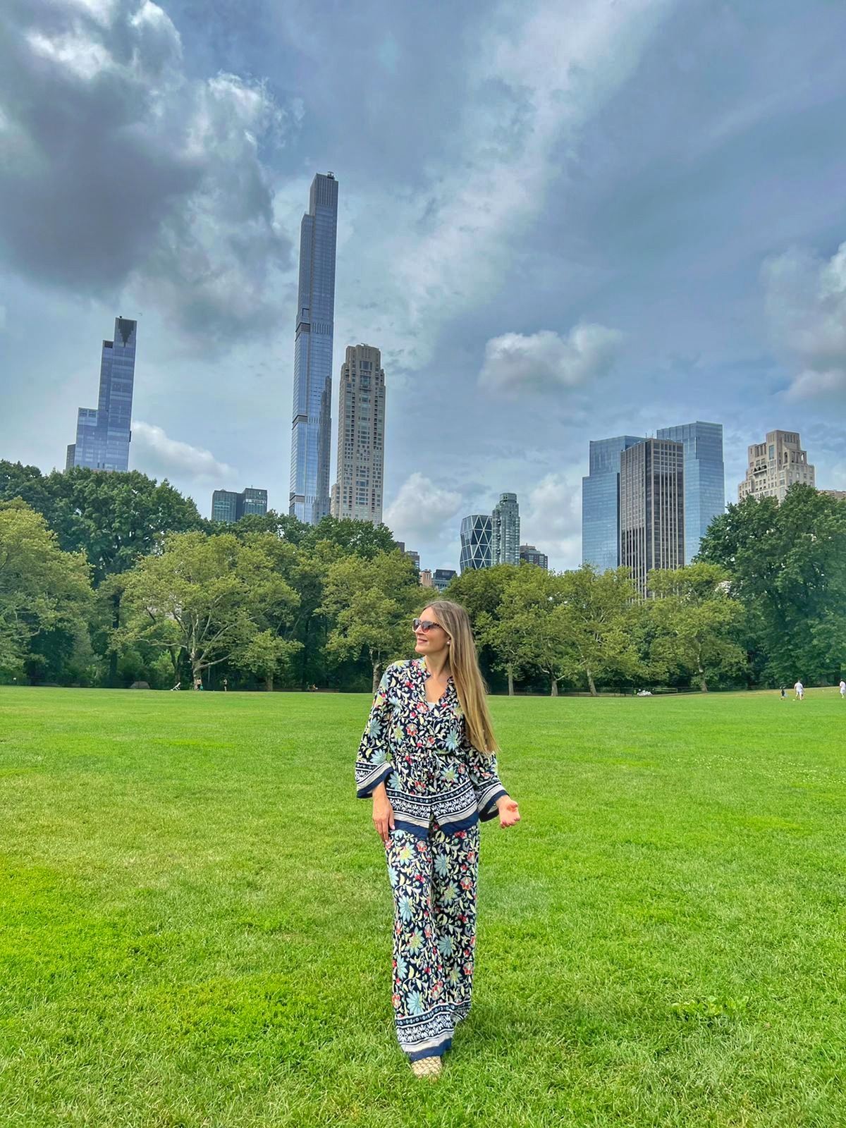 Central Park photo with New York City skyscrapers and skyline in the background.