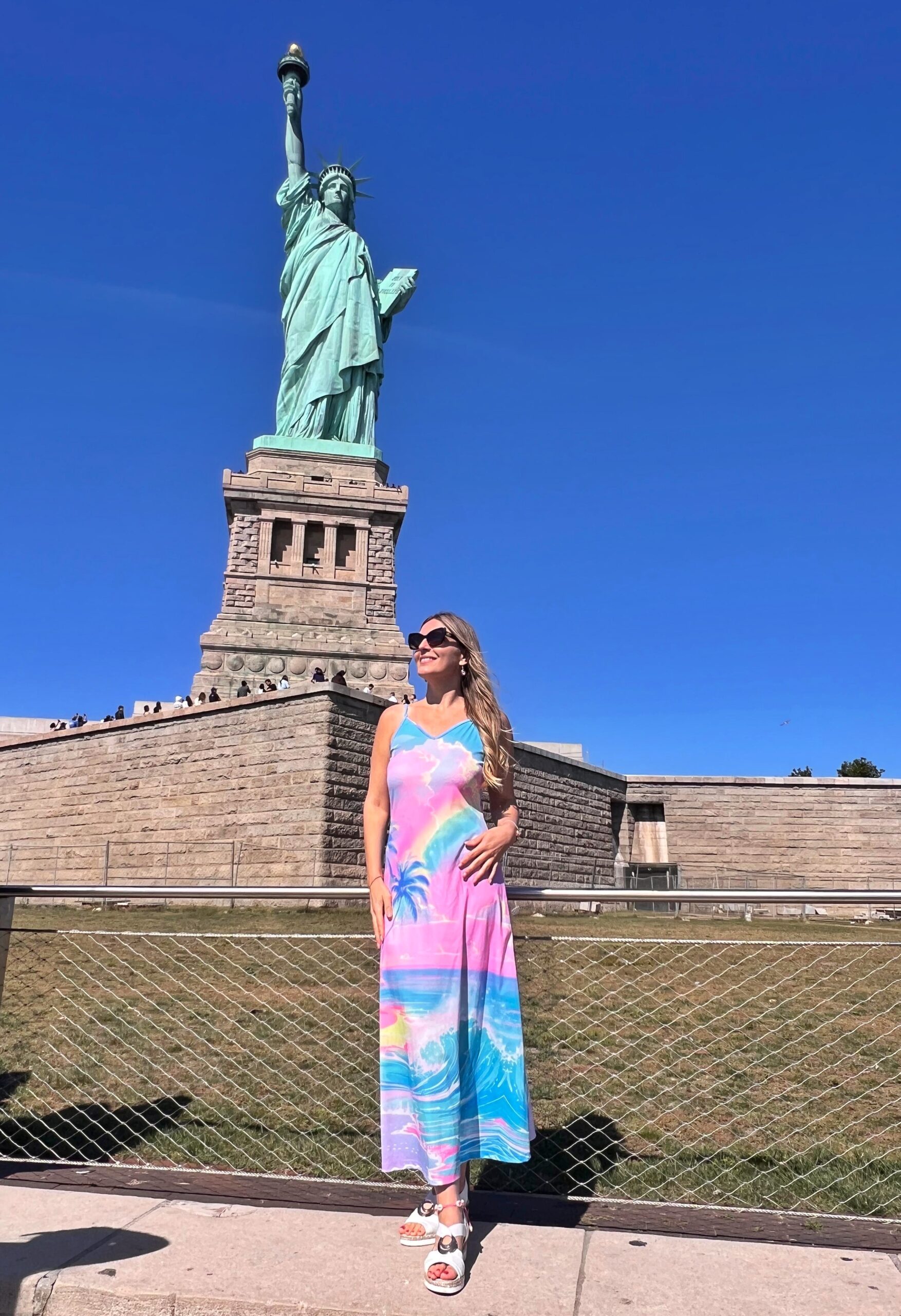 Standing in front of the Statue of Liberty on Liberty Island in New York