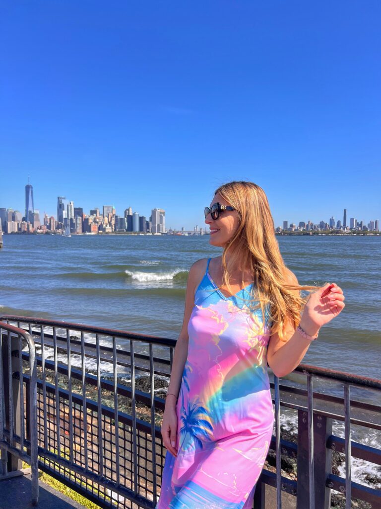 On Liberty Island with Manhattan skyscrapers behind me in New York City.