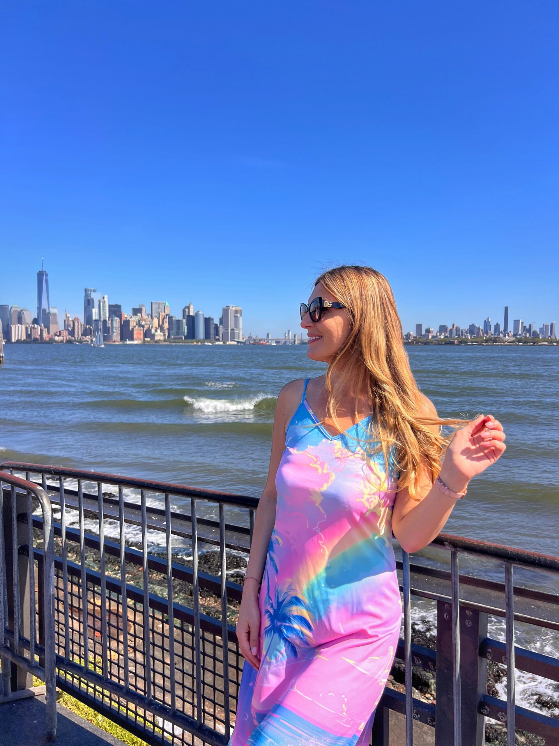 On Liberty Island with Manhattan skyscrapers behind me in New York City.