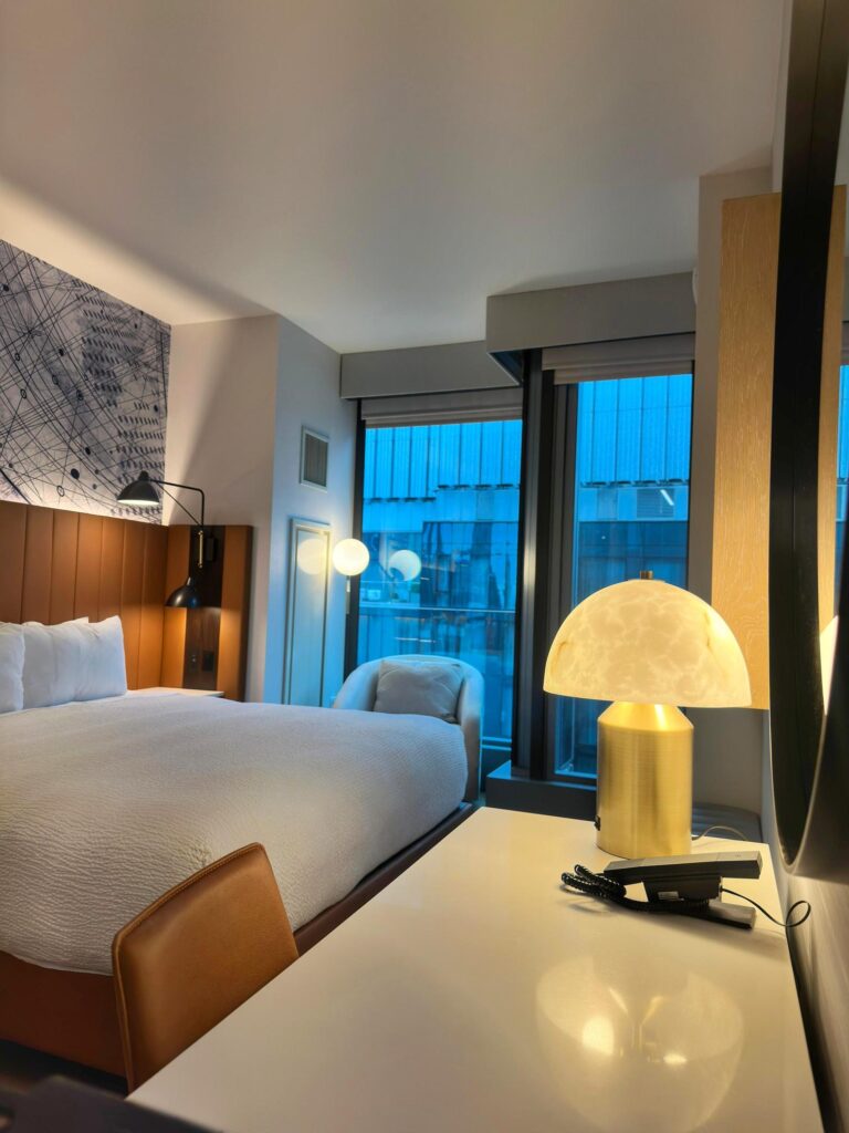 Modern hotel room with warm lighting and cozy ambience near Times Square, New York City.