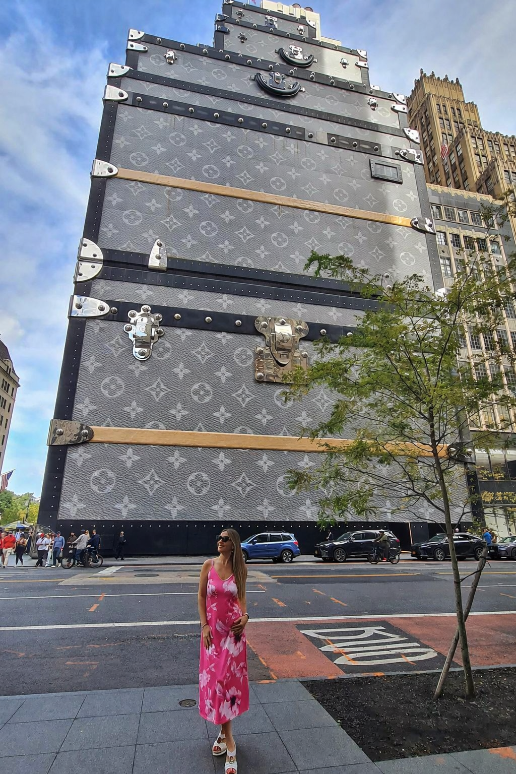 Woman posing outside Louis Vuitton store Fifth Avenue NYC