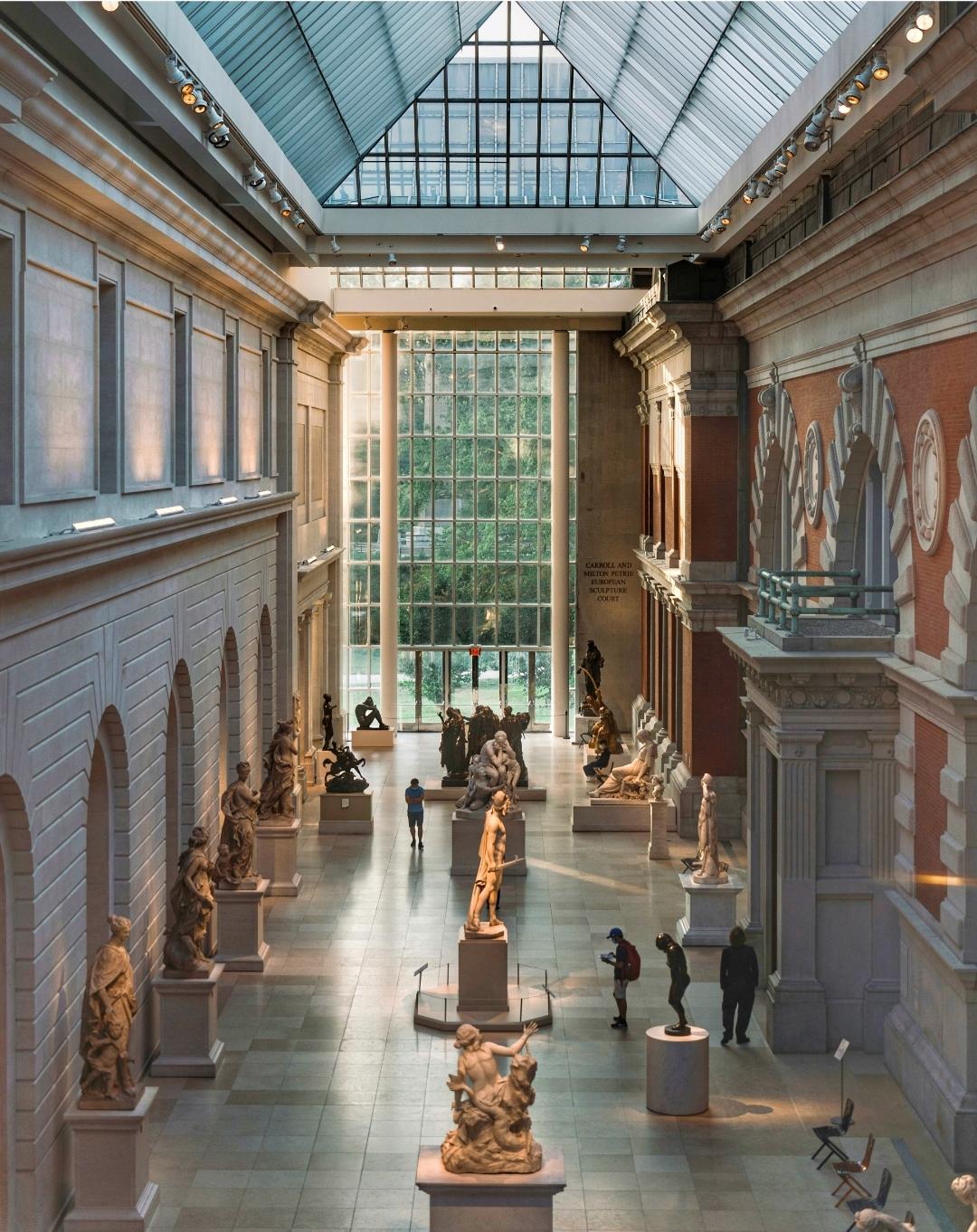 Interior of the Metropolitan Museum of Art showcasing classical European paintings and sculptures