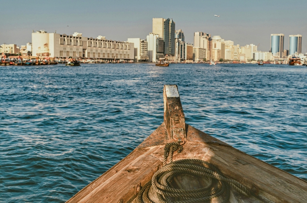 Traditional dhow boat cruise on Dubai Creek at sunset