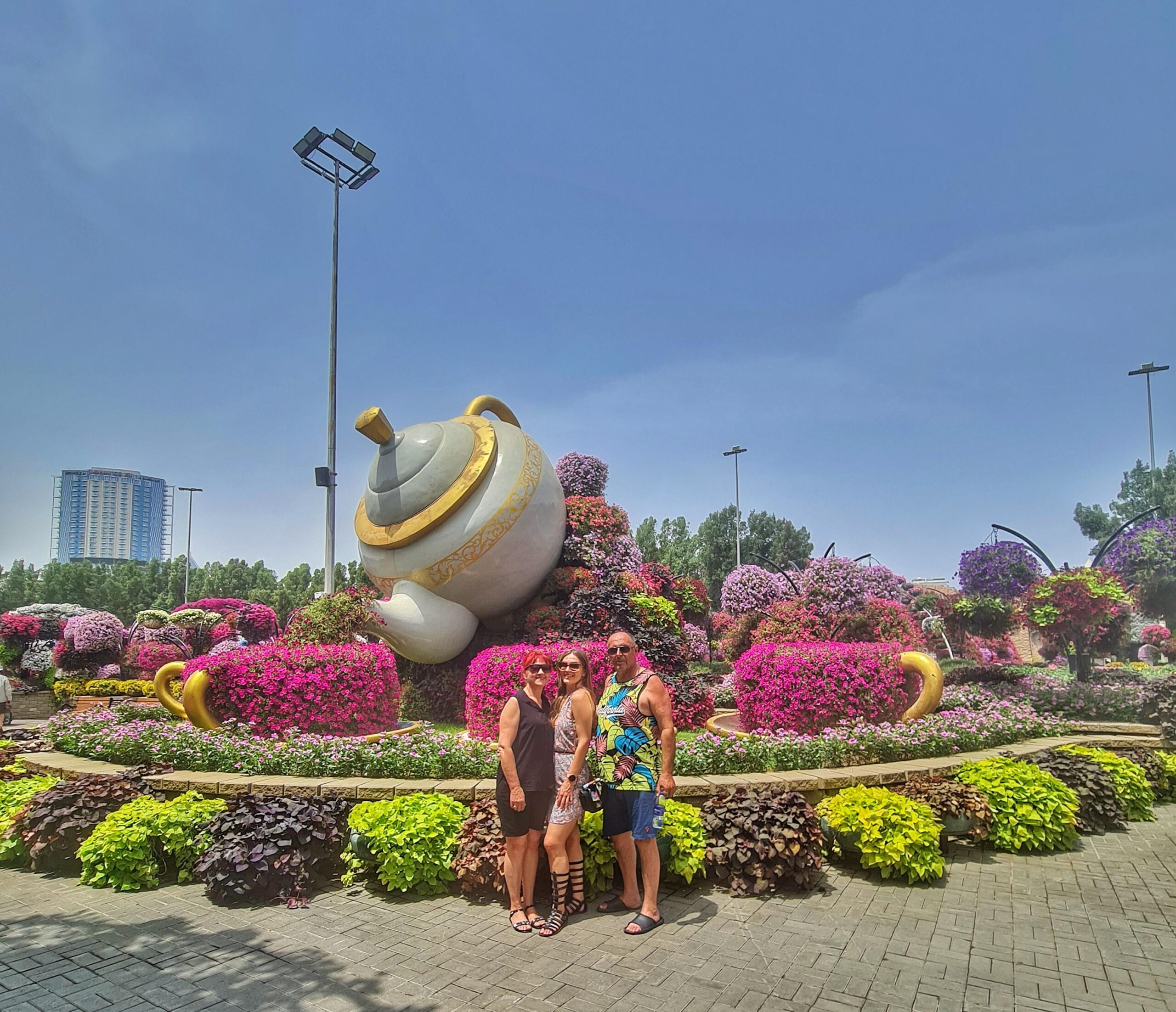 Family visiting Dubai Miracle Garden with vibrant flowers in the background