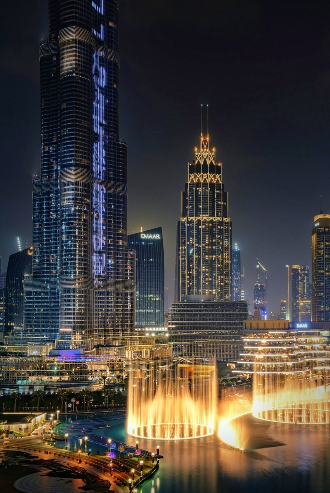 Dubai Fountain show at night with Burj Khalifa illuminated in the background